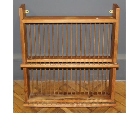 A 20th century pine plate rack, with slotted and stick retainers for thirty eight plates, 71.5 x 64cm