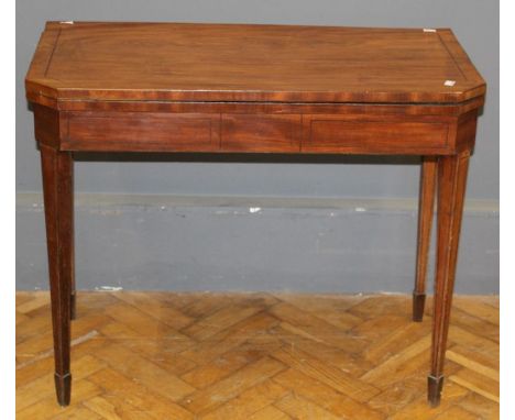 An early 19th century mahogany and strung card table, the chamfered rectangular top, folding to a double gate support, on squ