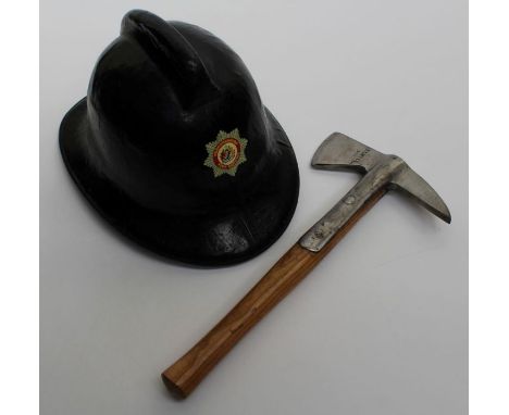 A 1950's War Department issue fireman's axe together with a stitched leather fireman's helmet bearing Bedfordshire Service cr