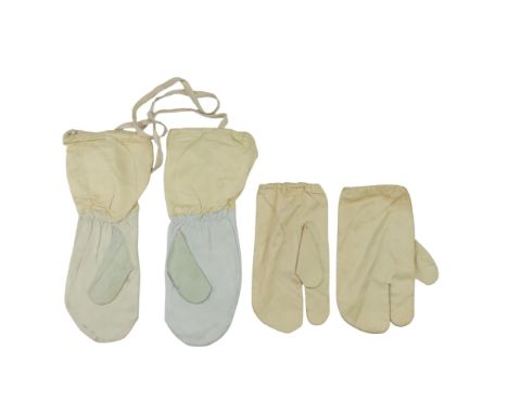 A pair of 1944 dated British army issue ski mittens together with a pair of 1942 dated snow camouflage cotton mittens