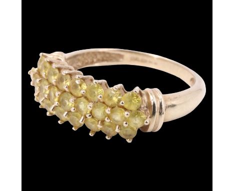 A contemporary chrysoberyl finger ring, having 25 brilliants, pave set in three curved rows, between D section shoulders each