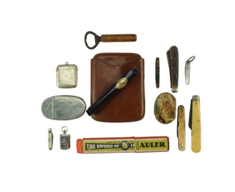 A group of collectors' items including an Edwardian pocket tobacco or snuff box, a nickel vesta case, a fob seal and case, a 