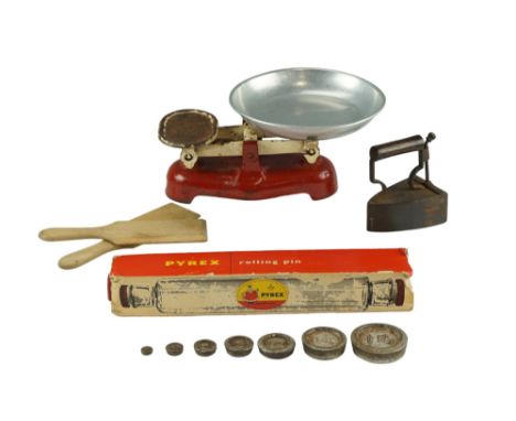 A box iron, butter patts, rolling pin in original carton and kitchen scales with weights