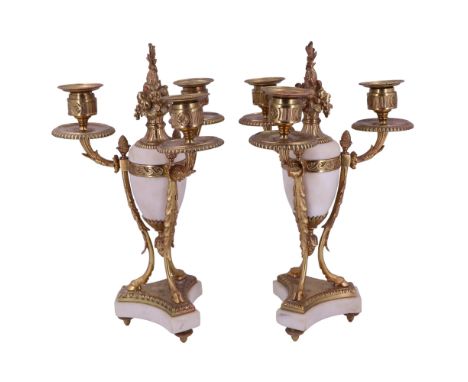 A pair of Louis XVI style gilt brass and alabaster three-branch candelabra, each comprising a central oviform pseudo urn with