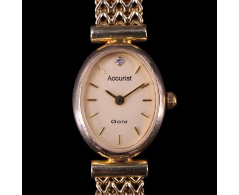 A lady's 2004 Accurist "Gold" 9 ct gold dress wristwatch, having a quartz movement and oval face set with a diamond at 12 o'c