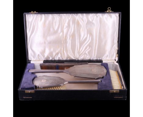 A cased 1940s Art Deco style silver-backed four-piece dressing table set having engine-turned decoration and comprising two b