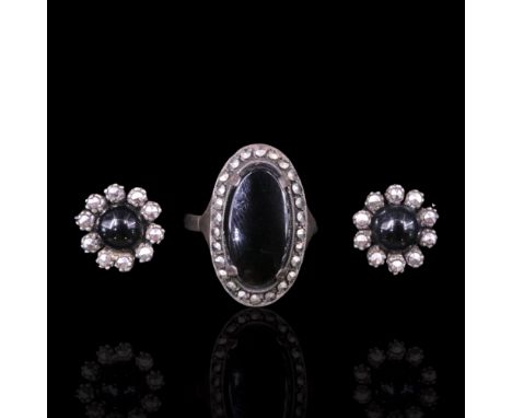 A vintage black onyx and marcasite ring together with a similar pair of flowerhead earrings, circa 1920s-1930s