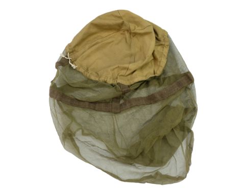 A 1944 dated British army helmet mosquito net