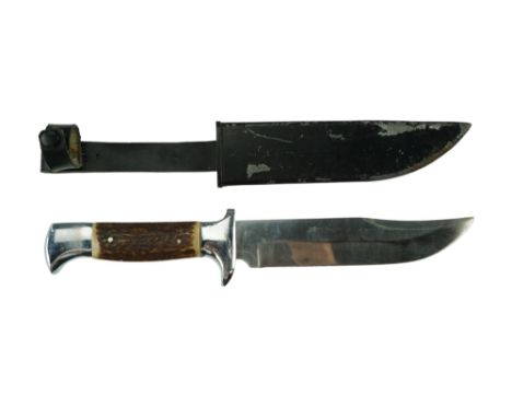 A late 20th Century sporting knife, having a Bowie-type blade and chromium-plated cast hilt with antler grip scales, in a bla