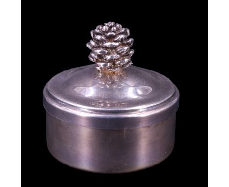 A 2001 silver pill or similar box, of drum form, its ogee domed slip lid having a pine cone shaped finial, the interior gilt,