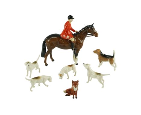 A Beswick "The Huntsman" figurine together with hounds and a fox, former 21 cm (small chip to hat rim) 