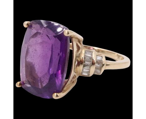 An Amethyst and diamond dress ring, having a radiant cut amethyst set on a pierced basket between terraced bands of channel s