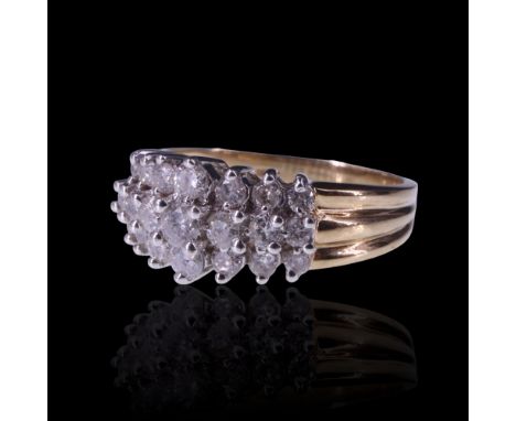 A contemporary diamond cluster ring, comprising three parallel terraced rows of subtly graded brilliants, claw set on a tripl