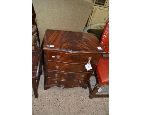 REPRODUCTION FLAME MAHOGANY VENEER SERPENTINE FRONT CHEST OF FOUR DRAWERS RAISED ON BRACKET FEET, 60CM WIDE