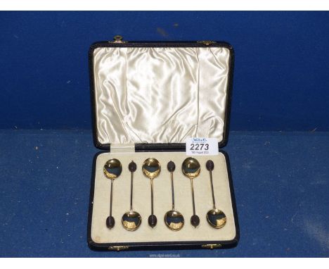 A cased set of six William Suckling Ltd. silver gilt and enamel coffee spoons, Birmingham 1934.