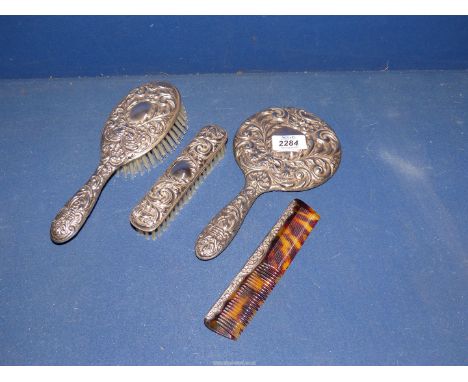 A silver backed dressing table set, Birmingham 1965, comprising hand mirror, comb, hairbrush, clothes brush, makers Broadway 