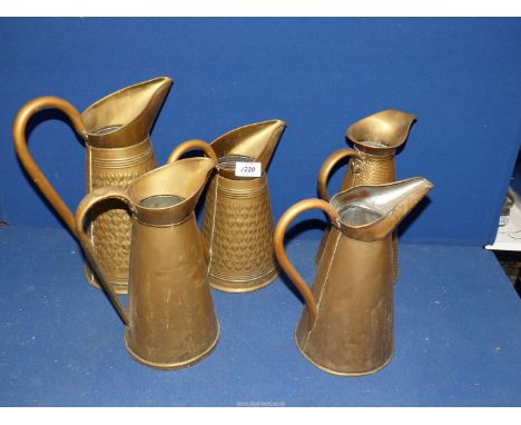Five brass water jugs/pitchers, two being marked "R. Penny and Son and Co., Wolverhampton" with embossed pattern.