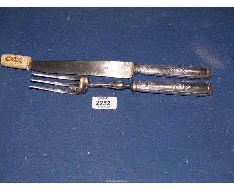 A French metal carving knife and fork set marked Paris to blade.