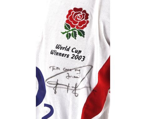 Signed Official England 2003 Winners Rugby Shirt - Signed 'take care my Friend Jonny Wilkinson' In black pen to upper left ch