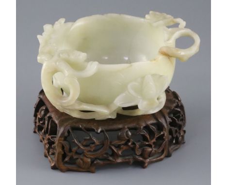 A Chinese pale celadon jade 'lotus' cup, late Ming dynasty, the cup formed as a lotus flower carved in high relief and open w