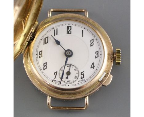 A lady's 1930's yellow metal (stamped 9c) 'Golfball?' manual wind wristwatch, with hinged cover, no strap, with Arabic dial a