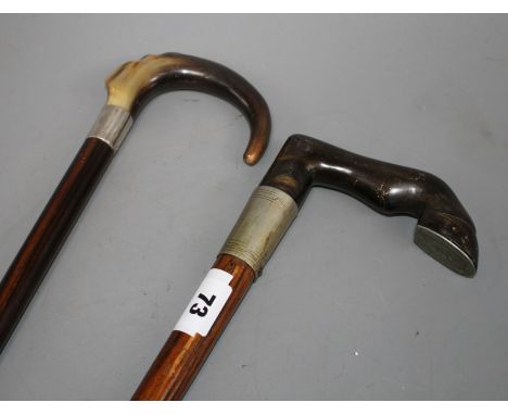 An Edwardian oak walking stick with pewter mounted horn horse hoof handle, 84cm and an ebony walking stick with silver banded