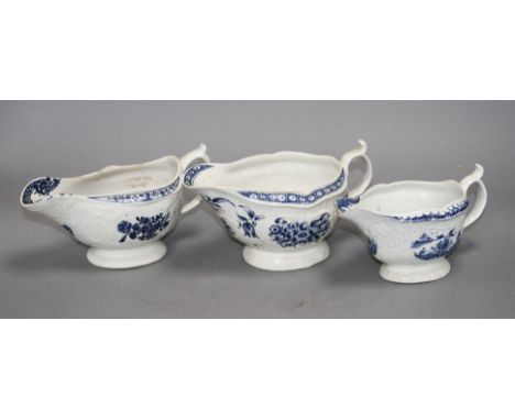 A Lowestoft blue and white sauceboat, c.1770 and two Worcester blue and white sauceboats, c.1758-65, Condition: The Lowestoft