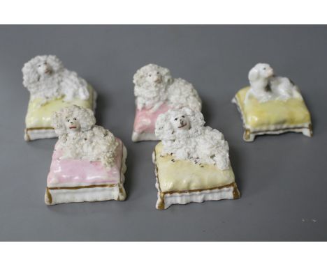 Five Staffordshire porcelain toy figures of four poodles and a King Charles spaniel recumbent on a cushion, c.1840-50, all wi