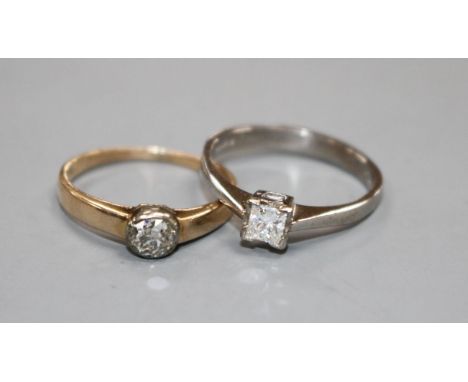 A modern 18ct white gold and princess cut solitaire diamond ring and a 585 and solitaire diamond ring, sizes M &amp; L, gross