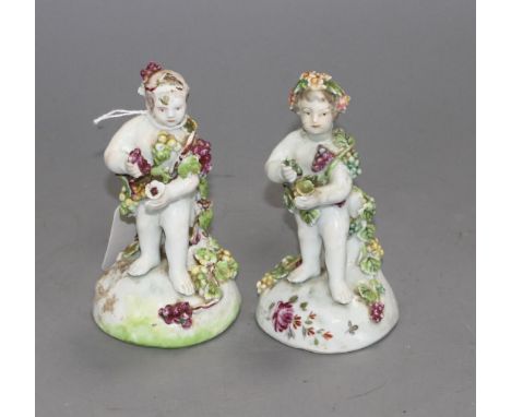 Two early Derby figures of cherubs, c.1756, H. 12cm Condition: Patch marks, both with tiny losses to flowers and leaves, the 