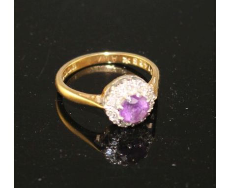 A modern 18ct gold, amethyst and diamond set circular cluster ring, size I, gross weight 3.2 grams. Condition: Amethyst diame