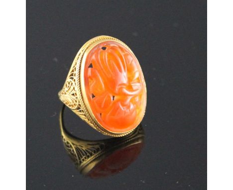 A 14k filigree yellow metal and orange chalcedony set dress ring, carved with fruit, size M, gross weight, 6 grams. Condition