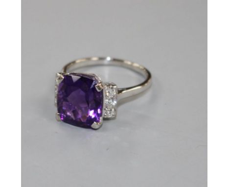 A white metal, amethyst and six stone diamond set dress ring, size R/S, gross weight 6.2 grams. Condition: Shank has been re-