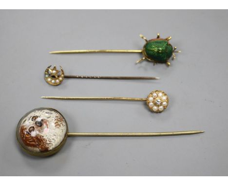 A yellow metal and scarab set stick, three others including Essex crystal style, pearl and pear and diamond, largest 82mm. Co