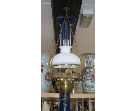 An Edwardian brass hanging oil lamp with opaque shade, overall drop 80cm Condition: Shade and flue possibly associated but ar