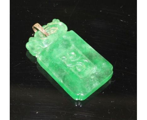 A simulated jade rectangular pendant with yellow metal mount (tests at 9ct gold), carved with scrolling motifs, 54mm, gross w