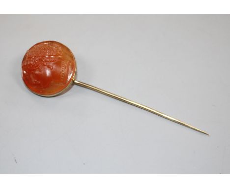 An early 20th century yellow metal and carnelian cameo set stick pin, carved with the head of a lady to dexter, 86mm, gross w