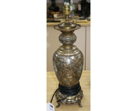 A 19th century French silvered and gilt brass table lamp, decorated with Oriental style flowers, scrolls and bamboo feet, ove