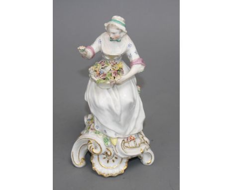 A Chelsea figure of a lady holding a flower basket, c.1765, H. 17.5cm Condition: unmarked, restoration to her right hand and 