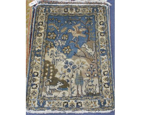A pair of Persian blue ground small mats, decorated with animals amongst trees and flowers, and three other mats with stylise