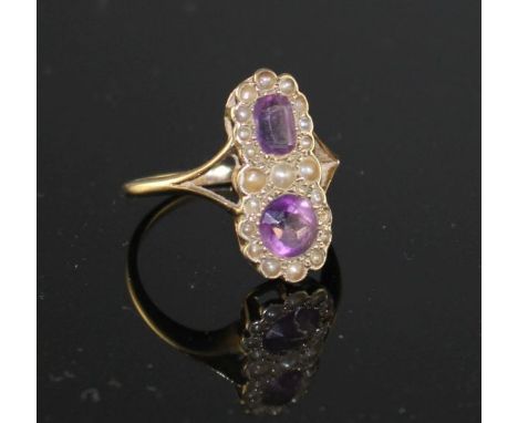 An early to mid 20th century 9ct, amethyst and seed pearl set double cluster dress ring, size O, gross weight 3.6 grams.Condi