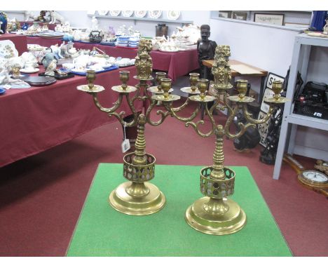 Pair of Heavy Brass Candelabra, each with four drip cups to twin branch, lion finial, ringed support on stepped circular base
