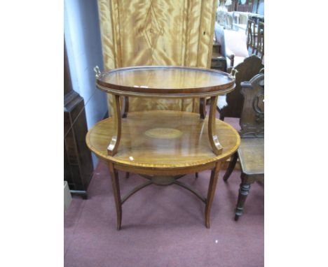 An Edwardian Mahogany Dumbwaiter, of oval form with detachable upper tray, the lower shelf featuring inlaid shell patera, on 