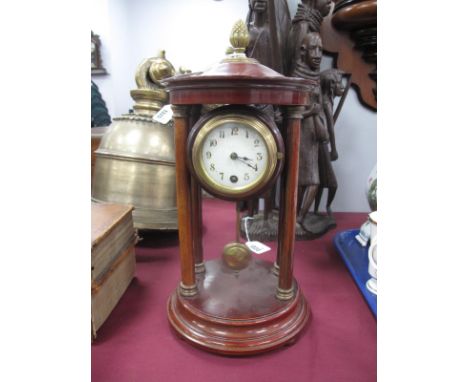 A XX Century Stained Mahogany Mantel Clock, with finial top, column supports, round dial stepped circular base.