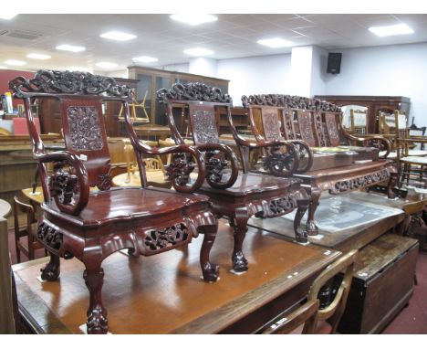 A Chinese Style Hardwood Settee Bench, and two matching hardwood armchairs, top rail with carved dragons, pierced splats, sol