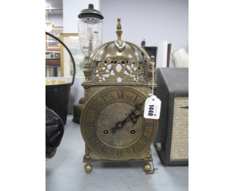 A XVII Style Brass Lantern Clock, with a finial top, circular dial, Roman numerals, with a German movement.