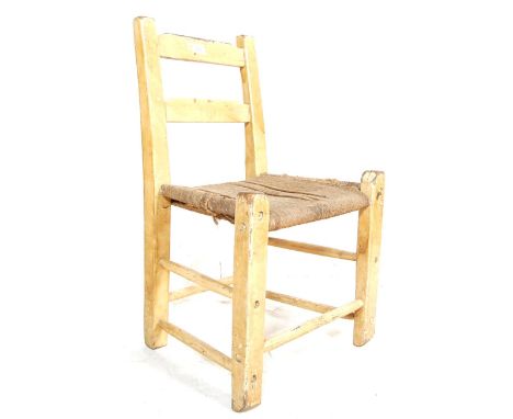 A Believed 19th / early 20th century farmhouse rustic Irish chair / dining chair. The chair having ladder backrest over a rop