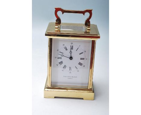 A vintage mid to late 20th Century Taylor and Bligh brass cased carriage clock having bevelled glass panelled sides with swin