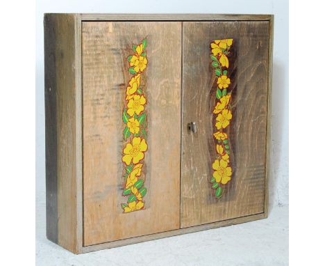 A vintage 20th Century workman's tool hanging cupboard / storage cabinet of rectangular form having twin hinged doors opening