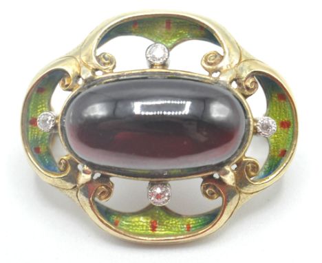 A vintage mid 20th Century 18ct gold diamond and garnet brooch having a central garnet cabochon set with four round cut diamo